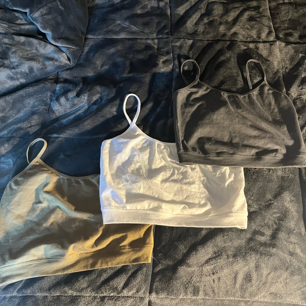 3 unworn cropped tanks.